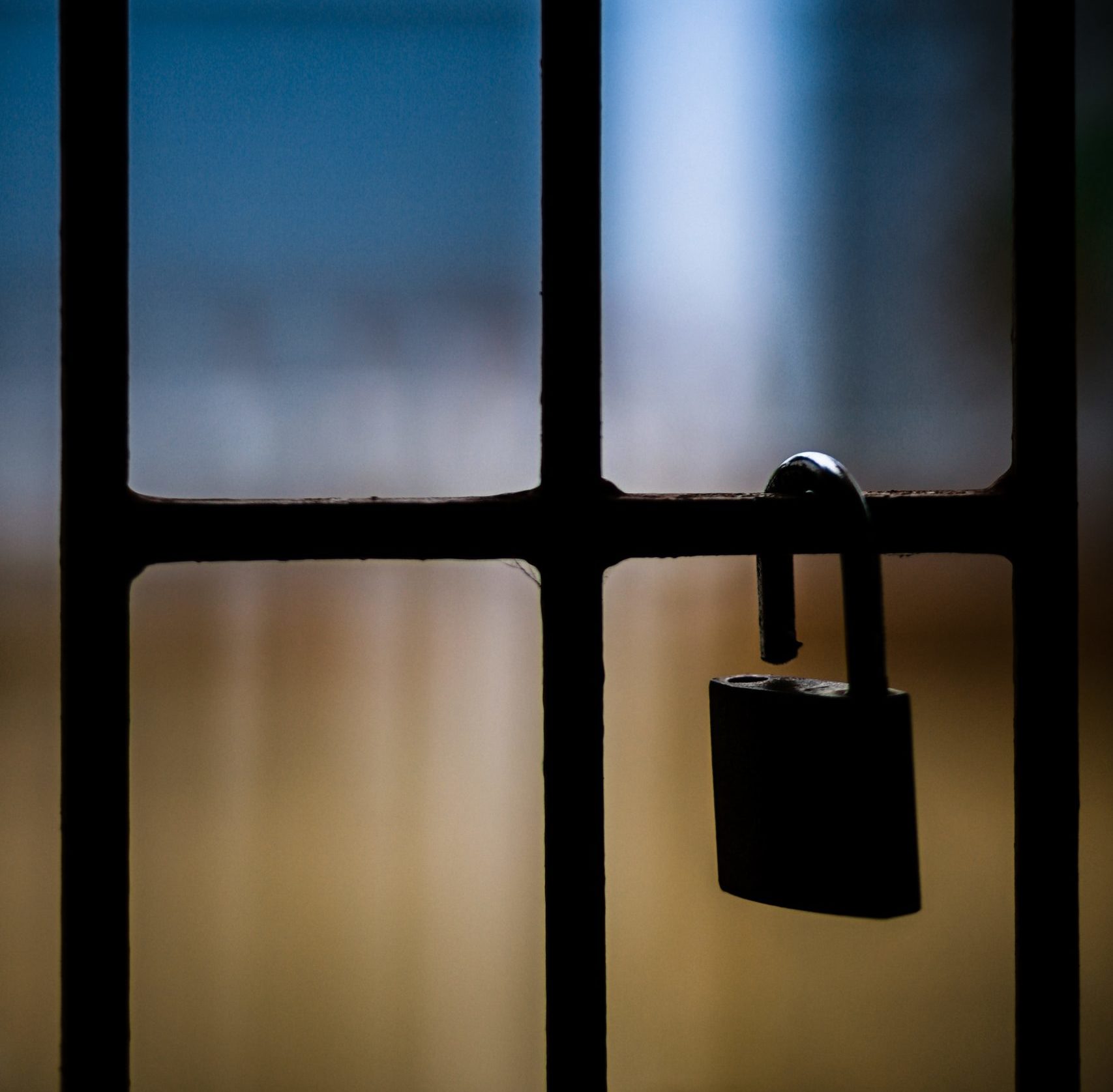 Bars with open padlock