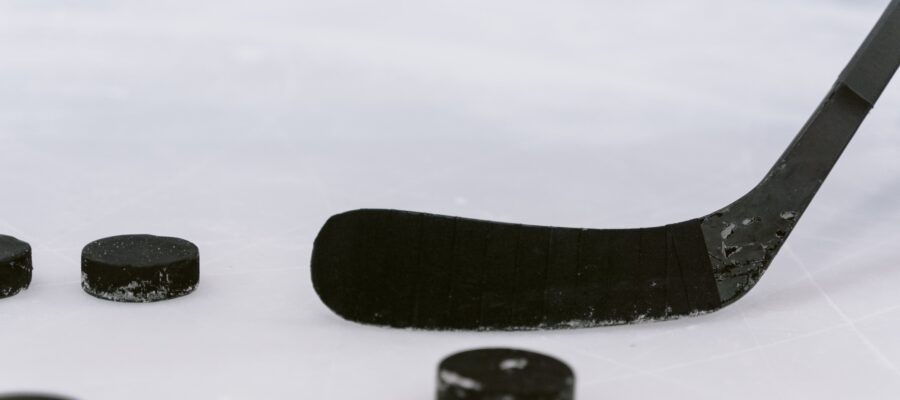 Photo by Tima Miroshnichenko: https://www.pexels.com/photo/close-up-shot-of-a-hockey-puck-and-hockey-stick-6847470/
